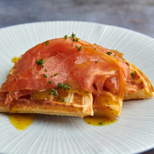 Smoked salmon on a bed of malted sourdough waffles with a sweet honey mustard sauce